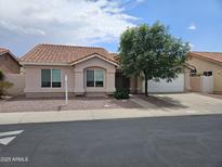 Charming single-story home with a well-manicured front yard and a classic tile roof at 3833 W Rene Dr, Chandler, AZ 85226