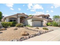 Inviting single-Gathering home with a well-manicured xeriscaped front yard and attached two-car garage at 4223 E Wildcat Dr, Cave Creek, AZ 85331