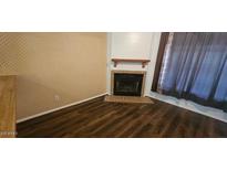 Inviting living room with classic fireplace and modern hardwood floors at 4601 N 102Nd Ave # 2202, Phoenix, AZ 85037