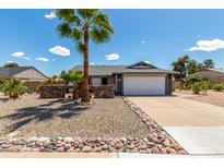 Charming single-Gathering home with a two-car garage and desert landscaping, including a tall palm tree at 5601 W Whitten St, Chandler, AZ 85226