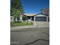 Charming single-story home featuring a two-car garage and well-maintained front yard at 696 W Shawnee Dr, Chandler, AZ 85225