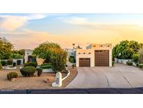Southwestern home featuring a concrete driveway, three-car garage, and desert landscaping under a bright sky at 9035 W Villa Chula --, Peoria, AZ 85383