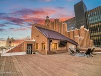 Expansive rooftop deck featuring lounge seating, a TV, and scenic city views, perfect for entertaining at 114 W Adams St # Ph, Phoenix, AZ 85003