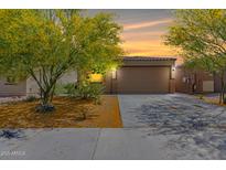 Inviting single-Gathering home with a 2-car garage, complemented by desert landscaping and a picturesque sunset backdrop at 12565 W Palmaire Ave, Glendale, AZ 85307