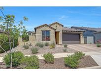 Charming single-story home featuring stucco exterior, desert landscaping, and a two-car garage at 14408 W Bloomfield Rd, Surprise, AZ 85379
