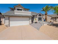 Charming home featuring a two-car garage, desert landscaping, and a mature palm tree at 14624 N 44Th St, Phoenix, AZ 85032