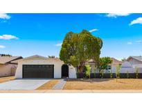 Charming single-story home with a well-manicured front yard and dark grey two-car garage at 1615 E Fremont Dr, Tempe, AZ 85282