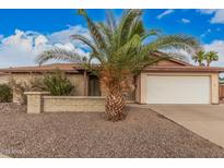 Charming single-story brick home featuring a two-car garage and a desert landscaped front yard at 1857 S El Marino Cir, Mesa, AZ 85202