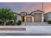 Charming single-story home showcasing a well-manicured lawn, neutral color palette, and a three-car garage at 21408 S 224Th Pl, Queen Creek, AZ 85142