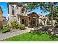 Charming two-story home with stone accents, landscaped front yard, and inviting walkway at 26678 N Babbling Brook Dr, Phoenix, AZ 85083