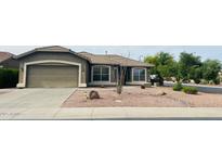 Charming single-story home with desert landscaping, a spacious driveway, and an attached two-car garage at 3176 E Palm Beach Dr, Chandler, AZ 85249