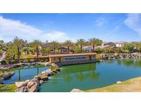 Scenic community pond with lush landscaping, waterfall feature, and a beautiful view of the surrounding neighborhood at 4077 S Sabrina Dr # 48, Chandler, AZ 85248