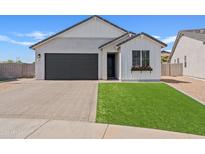 Charming single-story home featuring a dark gray garage door and a well-manicured lawn at 486 E Bamboo Ln, San Tan Valley, AZ 85140
