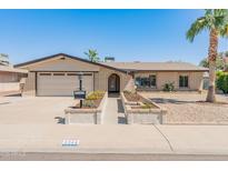 Charming single-story brick home with a well-manicured front yard and attached two-car garage at 4944 W Vista Ave, Glendale, AZ 85301