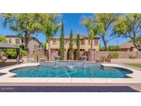 Beautiful backyard pool with fountains and lush landscaping at 614 E Benrich Dr, Gilbert, AZ 85295
