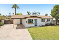 Charming single-story home with manicured lawn, mature landscaping, and an attached carport at 653 W Inglewood St, Mesa, AZ 85201