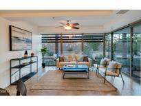 Bright living room with floor to ceiling windows and stylish furniture at 7161 E Rancho Vista Dr # 1013, Scottsdale, AZ 85251