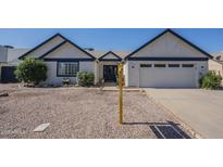 Charming single-story home featuring a well-maintained yard, two-car garage, and inviting front entrance at 717 E Temple St, Chandler, AZ 85225