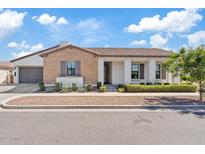 Charming single-story home with brick and stucco exterior, well-maintained landscaping, and a two-car garage at 10520 E Thorite Cir, Mesa, AZ 85212