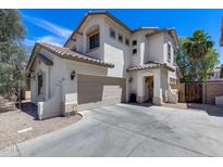 Inviting two-story home with a two-car garage, neutral stucco facade and well-maintained landscaping at 12107 N 66Th Ave, Glendale, AZ 85304