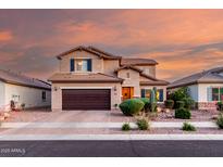 Charming two-story home with a brown garage door and desert landscaping, providing curb appeal at 2607 W Gray Wolf Trl, Phoenix, AZ 85085
