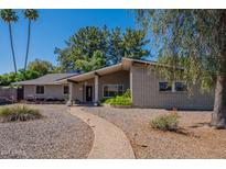 Charming single-story brick home with well-maintained landscaping and inviting walkway at 405 E Stanford Ave, Gilbert, AZ 85234