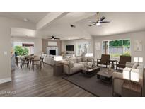 Spacious living room features modern ceiling fan, wood flooring and lots of natural light at 4913 E Acoma Dr, Scottsdale, AZ 85254