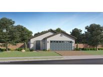 Charming single-story home with a well-manicured lawn and a two-car garage with a brick driveway at 9519 W Catalina Dr, Phoenix, AZ 85037