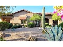 Charming exterior with a desert landscape, featuring a saguaro cactus and native plants at 9715 E Allison Way, Scottsdale, AZ 85262