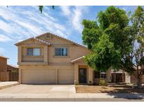 Charming two-story home featuring a spacious three-car garage and mature shade tree at 10909 W Frier Dr, Glendale, AZ 85307