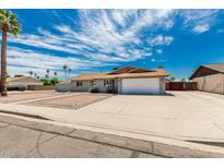 Street view of a single-story home with desert landscaping, showcasing its facade and curb appeal at 2327 E Pebble Beach Dr, Tempe, AZ 85282