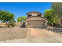 Charming two-story home featuring a two-car garage and desert landscaping at 2454 W Camp River Rd, Queen Creek, AZ 85144