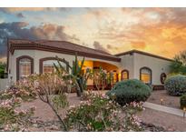 Lovely home with a colorful desert garden, stucco exterior, and beautiful sunset at 3001 E Winchcomb Dr, Phoenix, AZ 85032