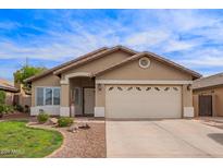 Charming single-story home with a well-maintained lawn, neutral stucco and a two car garage at 3971 E Heather Ct, Gilbert, AZ 85234