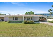 Charming single-story home with a well-manicured lawn, covered entry, and attached carport at 4219 E Catalina Dr, Phoenix, AZ 85018
