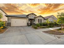 Charming one-story home with a two car garage, stone accents, and manicured landscaping at 4512 S Ferric Ave, Mesa, AZ 85212
