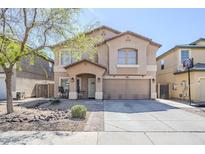 Charming two-story home featuring a spacious driveway, covered porch, and low-maintenance front yard at 45543 W Guilder Ave, Maricopa, AZ 85139