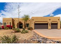 Charming home featuring a desert landscape, attached two-car garage, and barrel tile roofing at 5978 E Chuckwalla Trl, Cave Creek, AZ 85331