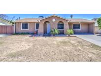 Charming single-story home with a blank canvas front yard ready for personalization and landscape at 6939 W Cambridge Ave, Phoenix, AZ 85035