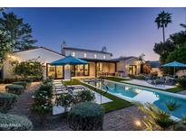 A stunning backyard features a modern pool and spa, lush landscaping, and outdoor living space at 7902 E Via Linda --, Scottsdale, AZ 85258