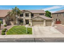 Charming two-story home with a well-manicured lawn, three-car garage and beautiful desert landscaping at 10234 E Lomita Ave, Mesa, AZ 85209
