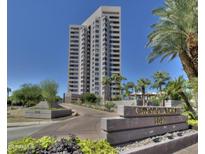 Modern condo building featuring a paved driveway, desert landscaping, and monument sign at 1040 E Osborn Rd # 1103, Phoenix, AZ 85014