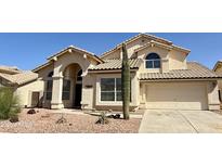 Charming single-Gathering home showcasing desert landscaping, a two-car garage, and beautiful architectural details at 11001 Clear Water --, Goodyear, AZ 85338