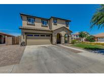 Charming two-story home with a neutral palette, a spacious driveway, and a well-maintained front yard at 21288 E Via Del Sol --, Queen Creek, AZ 85142