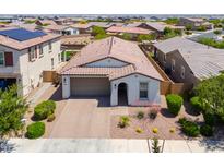 Inviting single-story home featuring a two-car garage, desert landscaping, and a charming covered entryway at 21595 S 225Th Way, Queen Creek, AZ 85142