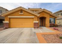 Charming single-story home with an attached two-car garage and a well-maintained desert landscape at 23814 W Chambers W St, Buckeye, AZ 85326