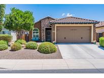 Charming single-story home with stone accents, a well-maintained front yard, and a two-car garage at 26071 W Sequoia Dr, Buckeye, AZ 85396