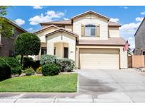 Charming two-story home featuring a well-manicured front yard and attached two car garage at 29339 N 67Th Ave, Peoria, AZ 85383