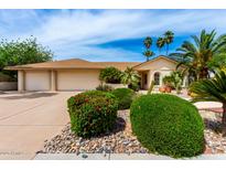 Charming single-level home with a desert landscape and three-car garage at 4556 E Paradise Ln, Phoenix, AZ 85032
