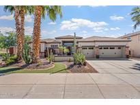 Beautiful desert home with a three-car garage, stone accents, and a meticulously landscaped front yard at 4589 N 154Th Ave, Goodyear, AZ 85395